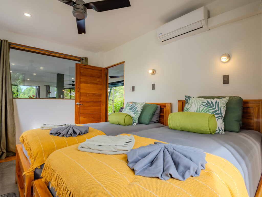 Ocean Suite second bedroom with twin single beds at Southern Drake Lodge